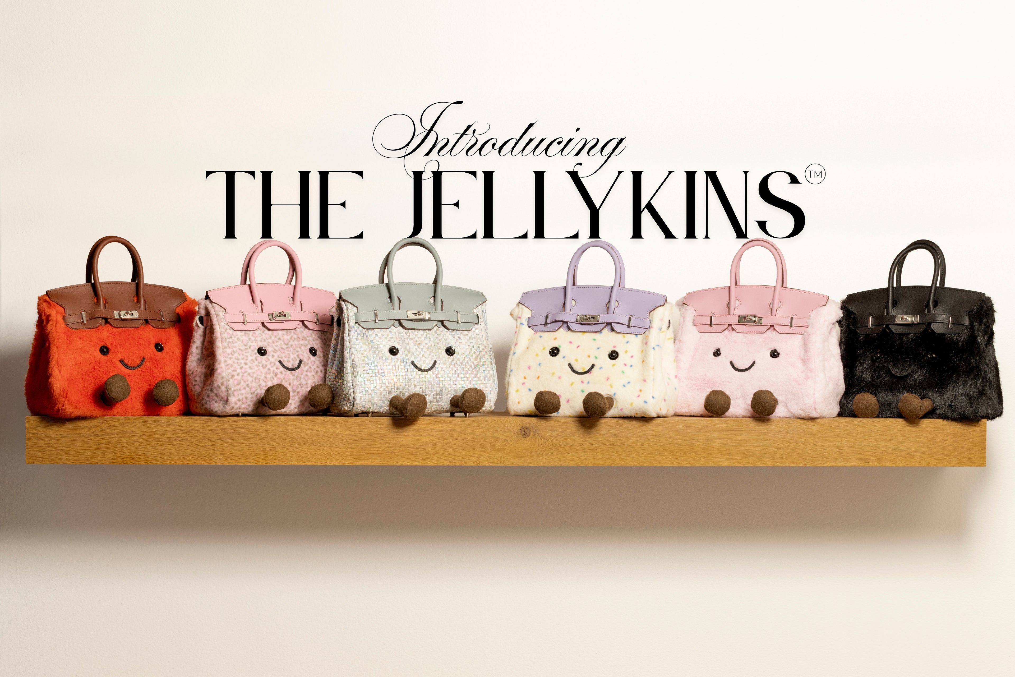 Row of small handbags with smiling faces on a wooden shelf, introducing 'The Jellykins'.